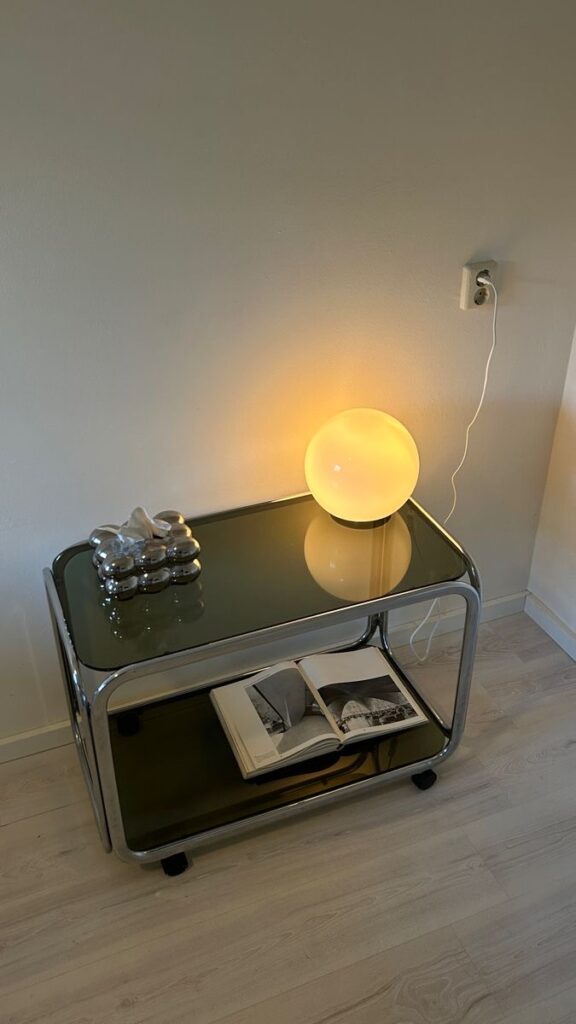 small table lamp with warm light creating cozy apartment atmosphere